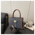 Dark blue pebbled leather tote bag with brown trim and gold chain link details - Blue