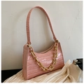 Detail shot of pink crocodile pattern leather underarm bag with decorative gold chunky chain - Pink