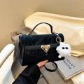 Black PU leather crossbody bag with textured lid, gold hardware and plush doll charm - Black With Pendant