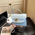 Light blue crossbody bag with marble texture flap and white plush monster charm accessory - Blue With Charm