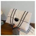 Detail of white quilted chain bag with V-shaped embossing on textured leather - White