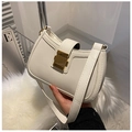 Detail showing creamy white faux leather texture and gold magnetic clasp on shoulder bag - White