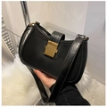 Close-up of black crescent underarm bag with lychee texture and gold rectangular buckle - Black