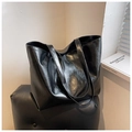 Detail view of large black tote bag with vintage oily leather texture and double straps - Black