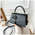 Detail of black matte leather satchel with top handle and golden buckle clasp - Black
