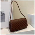 Close-up of brown quilted shoulder bag with fine stitching and gold metal hardware - Dark Brown