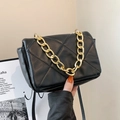 Quilted black crossbody bag with bold gold chain handle and sleek minimalist design - Black