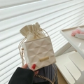 Creamy white chain bucket bag with quilted geometric texture and gold metal accents - White