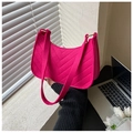 Detail of fuchsia textured felt crescent bag with V-shaped quilting held in soft lighting - Rose Red
