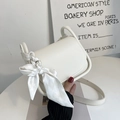Fashionable off-white PU shoulder bag with silk scarf detail and elegant curved flap - Off White