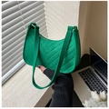 Close-up of green felt moon bag featuring elegant V-shaped quilted texture and bronze hardware - Green
