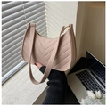 Detail of minimalist beige moon bag with V-shaped quilting and golden hardware - Khaki
