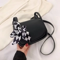 Minimalist black faux leather crossbody bag featuring a chic checkered silk scarf knot - Black