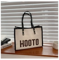 Minimalist canvas tote bag with black leather trim and brown HOOTO letter detail - Black