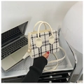 Classic black and white tweed mini tote bag with cream leather straps in a modern office setting - White