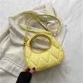 Yellow half-moon crossbody bag with rhomboid quilting and circular cutout handle - Yellow
