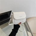 White faux leather crossbody bag with quilted texture and fashion trend logo detail - White