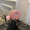Pink quilted oval crossbody bag with gold floral clasp and chain strap with pompom - Pink / Small