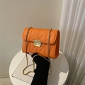 Chic orange quilted crossbody bag with V-shaped stitching and golden chain strap - Orange