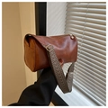 Side view of vintage brown cylindrical bag with textured PU leather and woven strap - Brown