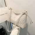 Minimalist beige quilted shoulder bag featuring luxury diamond stitching and cord straps - Off White