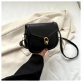 Detail of elegant black leather crossbody bag featuring a stylish gold double ring buckle clasp - Black