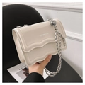 Borsa a tracolla color crema con patta ondulata e ciondolo a forma di globo su catena - Bianco