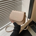 Chic beige saddle crossbody bag in faux leather featuring fashion trend logo print - Khaki