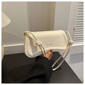 Detail of cream white leather shoulder bag with knotted strap and gold metal aglets - White