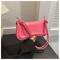 Detail of pink glossy leather bag with rope knot strap and brand logo close-up - Pink
