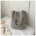 Detail shot of the beige corduroy tote bag with a minimalist patch and top handles - Light Gray