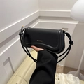 Bolso sobaco minimalista de cuero negro con logo dorado y detalle de correa anudada - Negro