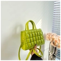 Close-up of lime green quilted PU leather handbag featuring dual handles and fine strap - Green
