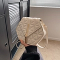 Chic beige hexagonal crossbody bag featuring geometric quilting and gold tassel charm - Off White