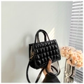 Detail of black quilted leather handbag with double handles and fine shoulder strap - Black