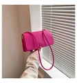Close-up of fuchsia minimalist rectangle handbag with sleek leather texture and metal buckle - Rose Red