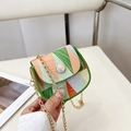Chic geometric mosaic mini crossbody bag with gold chain strap held in a hand - Green