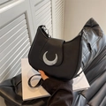 Minimalist black crescent shoulder bag with silver moon clasp and matte leather finish - Black