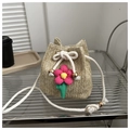 Beigefarbene Stroh-Beuteltasche mit rosa Blumenanhänger und weißem Seilschultergurt - Khaki