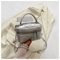 Detail view of a silver quilted box bag with a metal camellia clasp and chain strap - Silver Large