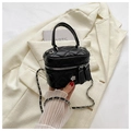 Close-up of quilted black mini box bag with chain strap and silver flower charm - Black Small