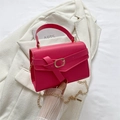 Fuchsia minimalist chain handbag with leather buckle on white blazer and arts book - Rose Pink