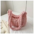 Close-up of soft pink popcorn texture fabric on a stylish crescent shoulder bag - Pink