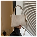 Detailed view of cream straw woven texture with smooth leather handle and gold hardware - Off White