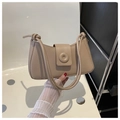 Detail of minimalist beige leather underarm bag with knot strap and round buckle clasp - Khaki