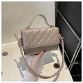 Detail of beige quilted leather handbag featuring elegant diamond stitching and gold hardware - Khaki