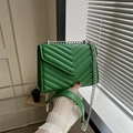 Green chevron quilted crossbody bag featuring a silver metal chain strap and leather pad - Green