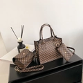 Vintage brown three-piece handbag set with tote bag and crossbody pouch on table - Brown