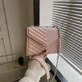 Pink quilted crossbody bag with silver chain strap and minimalist V-shape flap design - Pink