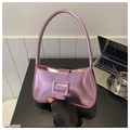 Metallic bright pink baguette bag with large square buckle in a lifestyle office setting - Rose Pink